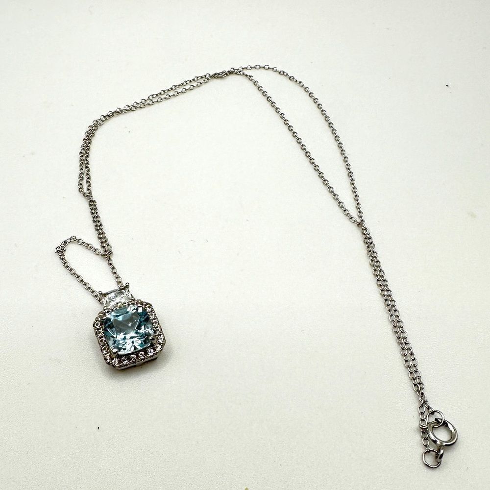 Marked DHJ 925, blue topaz, and‎ CZ accented sterling silver necklace!
